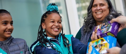 For Cookie Sellers Girl Scouts holding cookie boxes