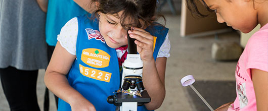 Girl Scout does a STEM activity with a microscope
